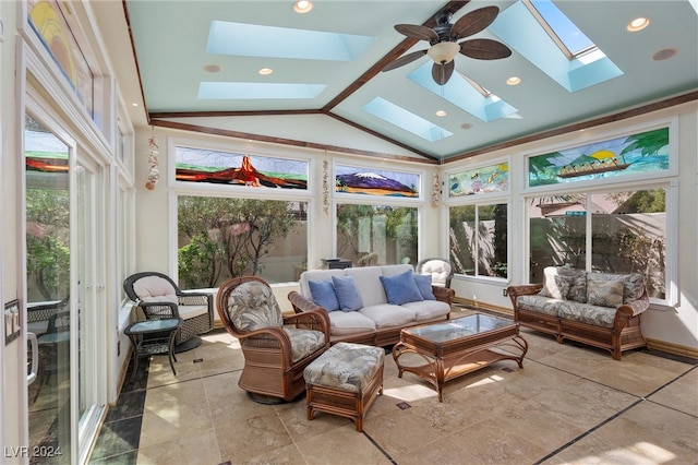 sunroom / solarium featuring ceiling fan, lofted ceiling with skylight, and a healthy amount of sunlight