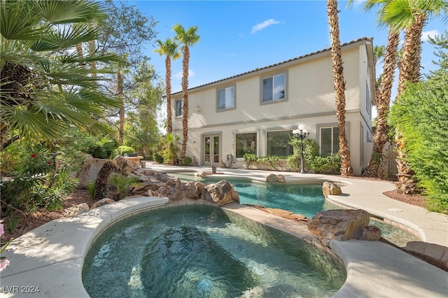 view of swimming pool with an in ground hot tub and a patio area