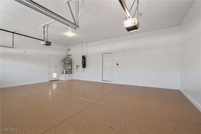 garage with water heater and a garage door opener