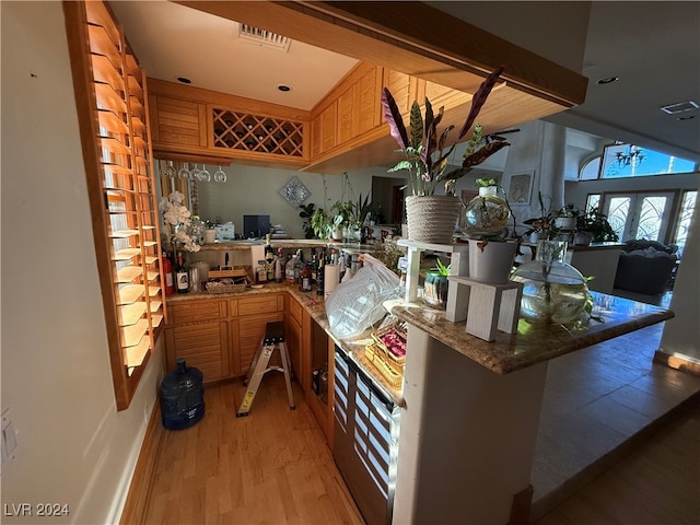 kitchen featuring light hardwood / wood-style flooring and kitchen peninsula