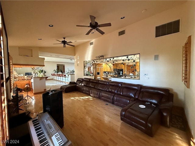 living room featuring ceiling fan and light wood-type flooring