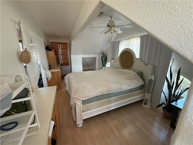 bedroom featuring vaulted ceiling, wood-type flooring, and ceiling fan