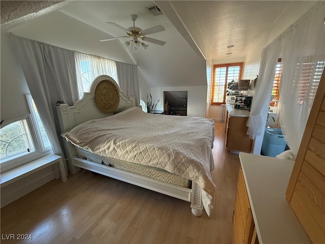 bedroom featuring hardwood / wood-style floors, multiple windows, and ceiling fan