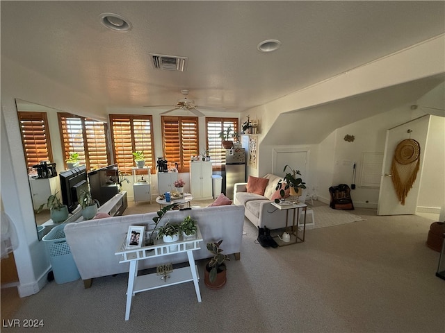 living room with ceiling fan and carpet flooring