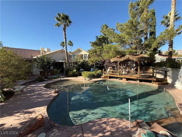 view of swimming pool with a wooden deck