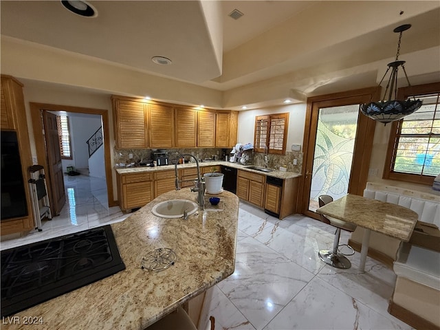 kitchen featuring sink, hanging light fixtures, an inviting chandelier, and tasteful backsplash