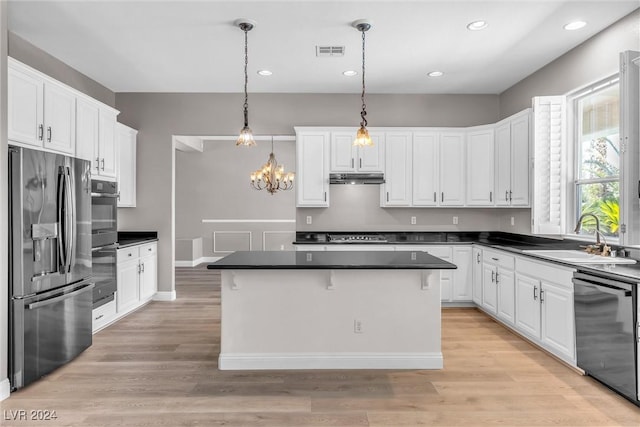 kitchen featuring white cabinets, sink, a center island, and black appliances