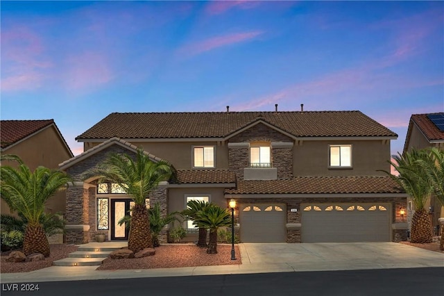 mediterranean / spanish home featuring a garage