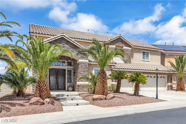 mediterranean / spanish-style home featuring a garage