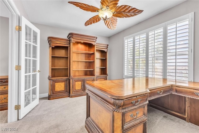 carpeted office with ceiling fan and french doors