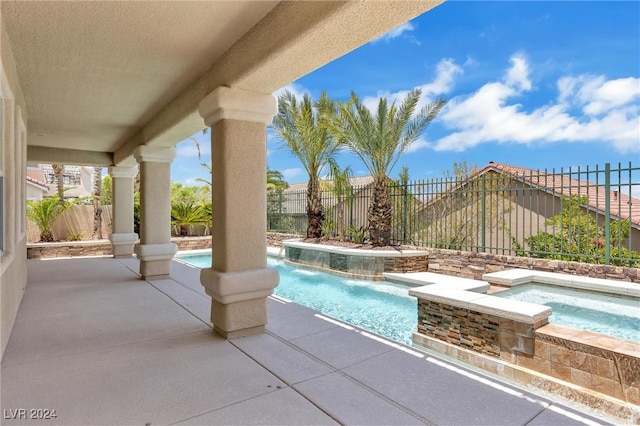 view of swimming pool with a patio area, an in ground hot tub, and pool water feature