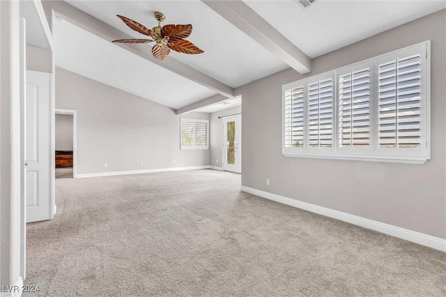 carpeted empty room with ceiling fan and lofted ceiling with beams