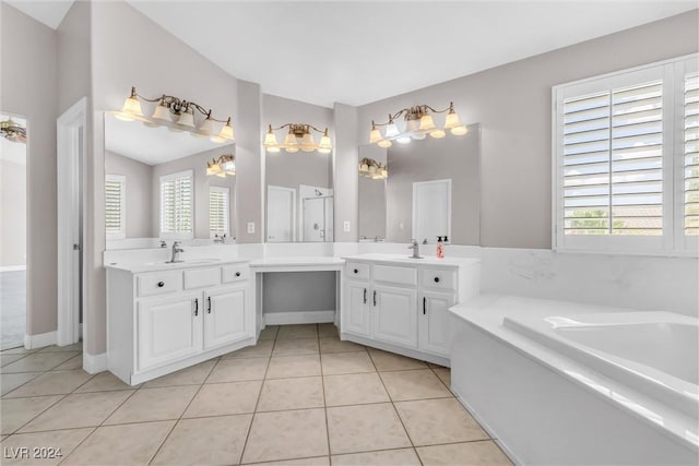 bathroom featuring tile patterned floors, a tub to relax in, a chandelier, vaulted ceiling, and vanity