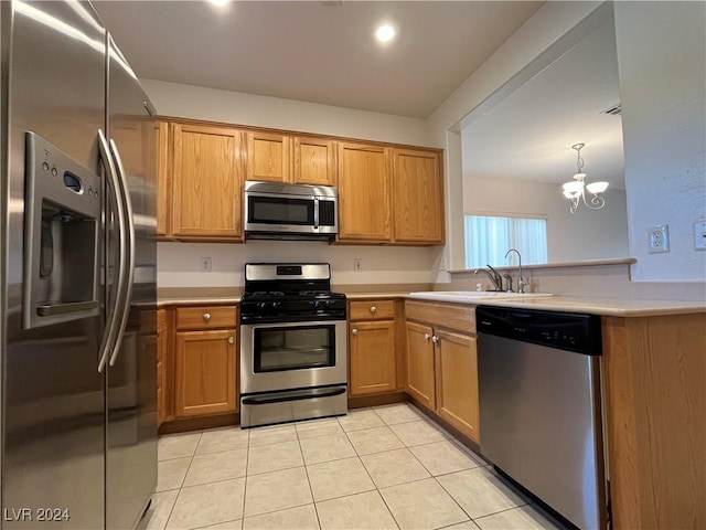 kitchen featuring light tile patterned flooring, sink, stainless steel appliances, and an inviting chandelier