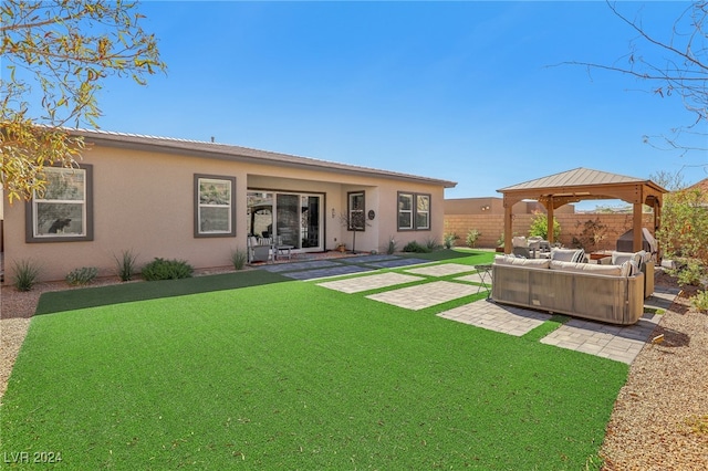 back of house featuring a patio, a gazebo, a lawn, and an outdoor hangout area