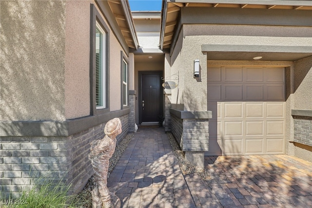 view of exterior entry with a garage