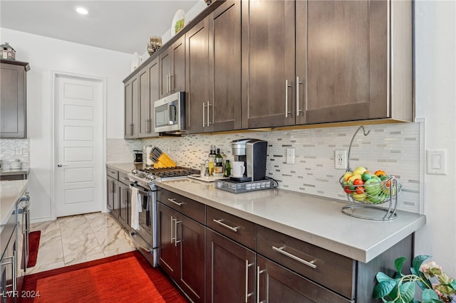 kitchen featuring dark brown cabinets, stainless steel appliances, and tasteful backsplash