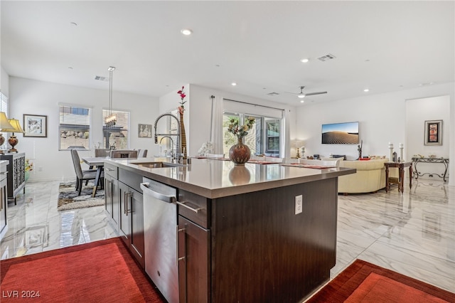 kitchen featuring ceiling fan, an island with sink, hanging light fixtures, sink, and dishwasher