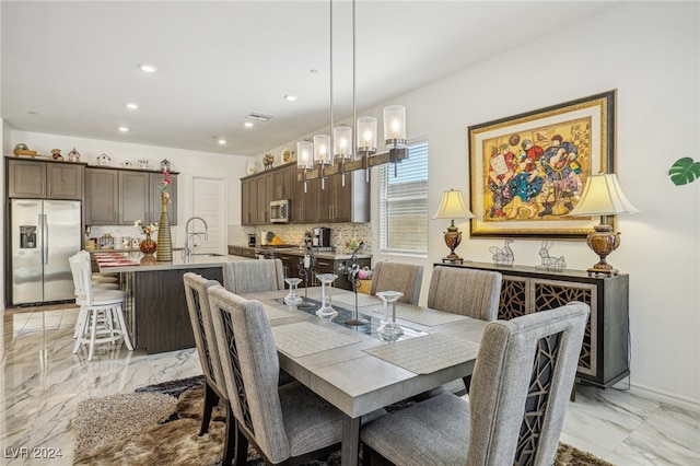 dining area featuring a notable chandelier and sink