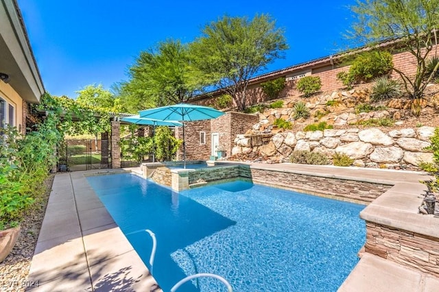 view of pool with an in ground hot tub and a patio area