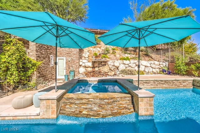 view of pool with an in ground hot tub