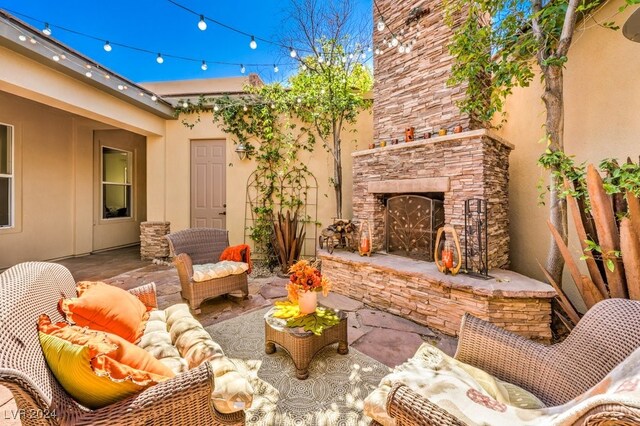 view of patio / terrace with an outdoor stone fireplace