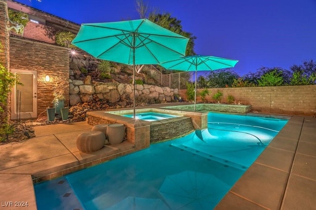 view of swimming pool with an in ground hot tub