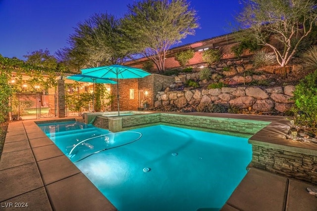 view of pool with an in ground hot tub