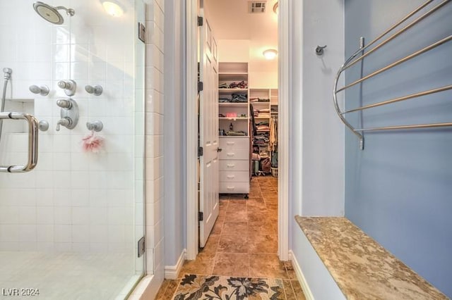 bathroom featuring tile patterned flooring and walk in shower