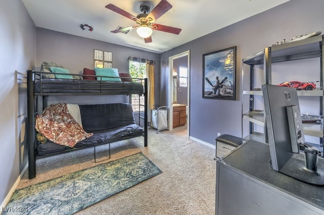 carpeted bedroom with ceiling fan and ensuite bath