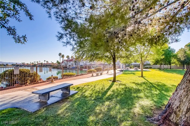 view of home's community with a yard and a water view