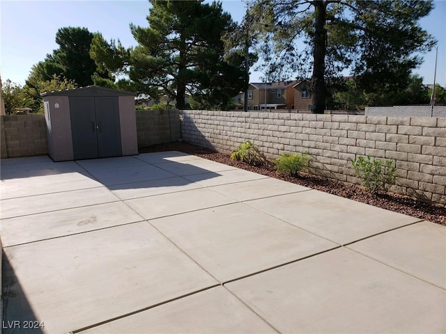 view of patio featuring a storage shed