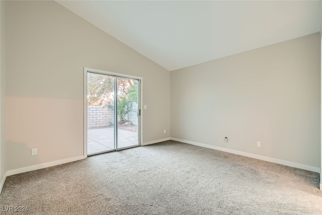 carpeted empty room featuring vaulted ceiling