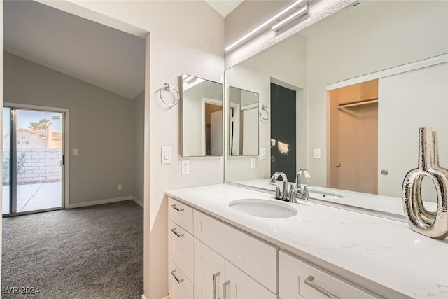 bathroom with vanity and vaulted ceiling