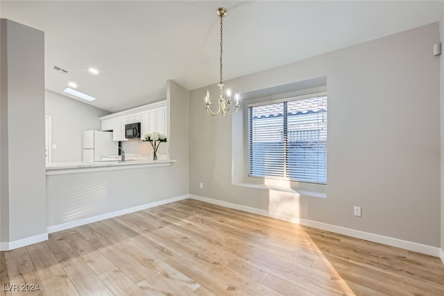 interior space with light hardwood / wood-style floors and a chandelier