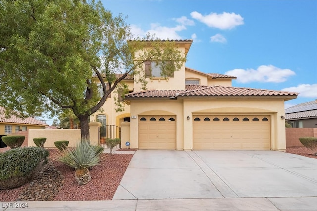 mediterranean / spanish house with a garage