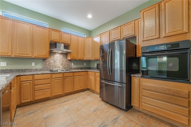 kitchen featuring stone countertops, backsplash, stainless steel appliances, and range hood