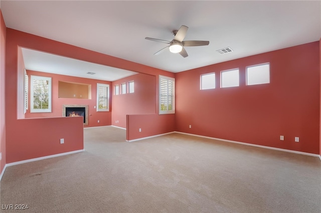 unfurnished room featuring ceiling fan and light colored carpet