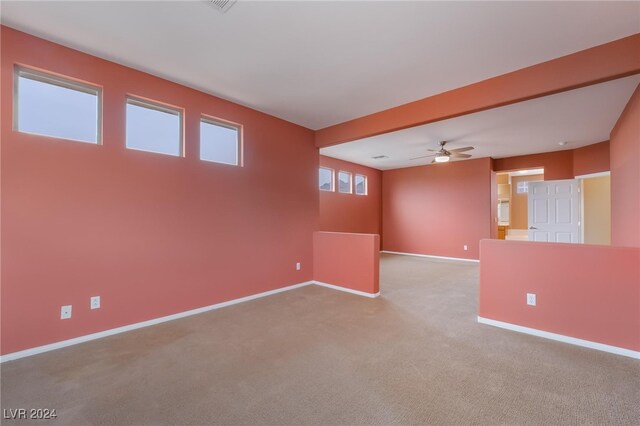 carpeted empty room featuring ceiling fan