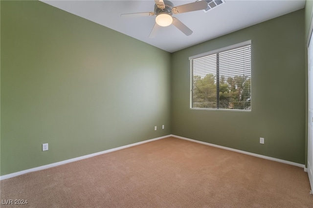 empty room featuring carpet flooring and ceiling fan