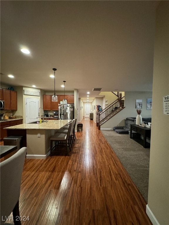 dining area featuring sink and dark hardwood / wood-style flooring