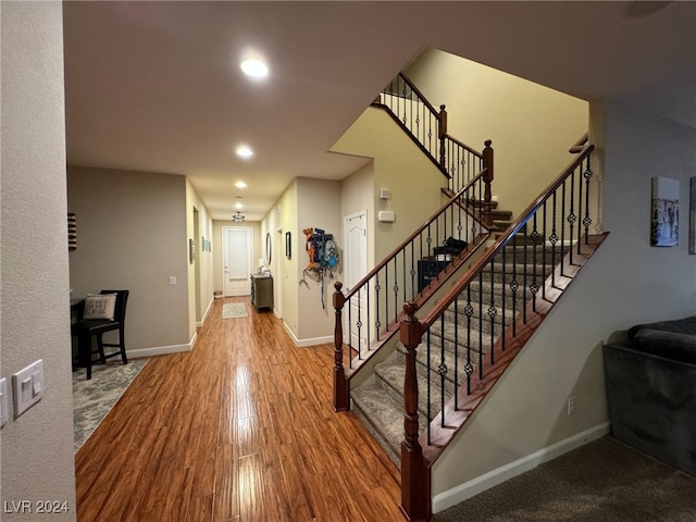 staircase featuring wood-type flooring