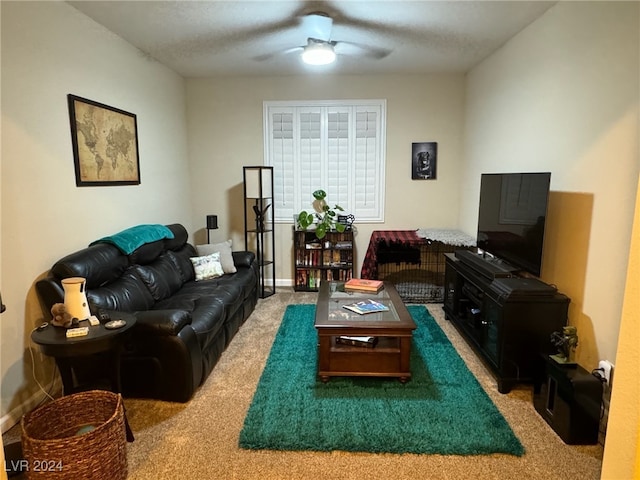 carpeted living room with a textured ceiling and ceiling fan