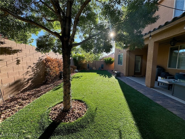 view of yard featuring ceiling fan and a patio area