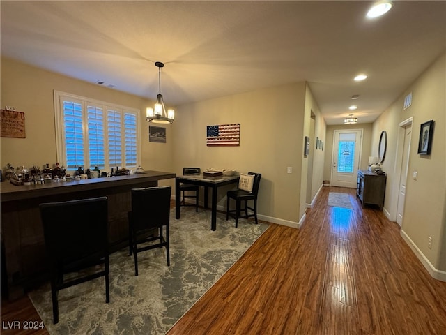 dining area featuring a notable chandelier and hardwood / wood-style floors