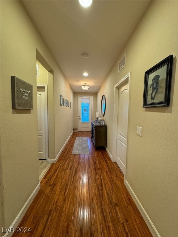 hall with dark hardwood / wood-style floors