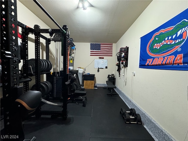 workout room with a textured ceiling