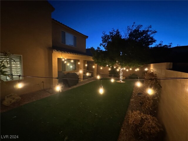 yard at night featuring a patio area