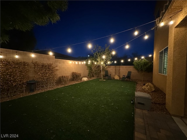 view of yard at twilight