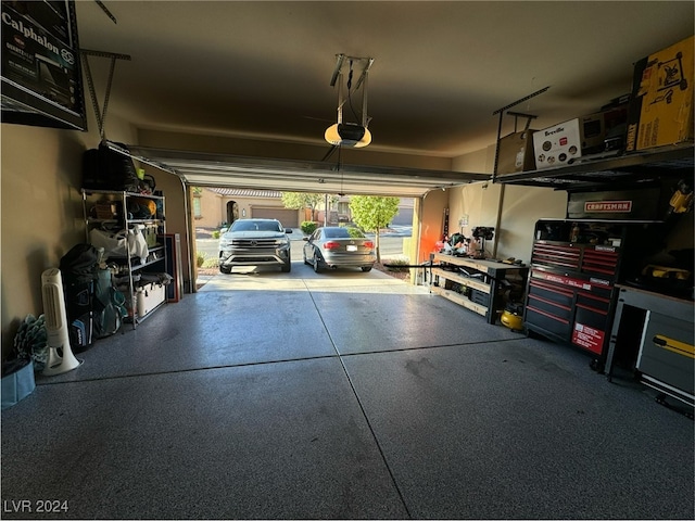 garage featuring a garage door opener and a carport